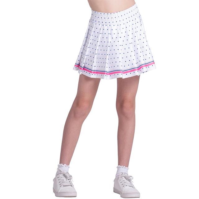 A person wearing a white polka dot skirt and sneakers.