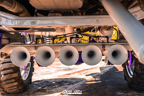 Rear undercarriage Chad's 2017 Jeep Wrangler four white train horn bells metallic purple air tank gauge purple axle differential cover white coil springs chrome wheels Conductor's Special 244K Spare Tire Delete photo 4