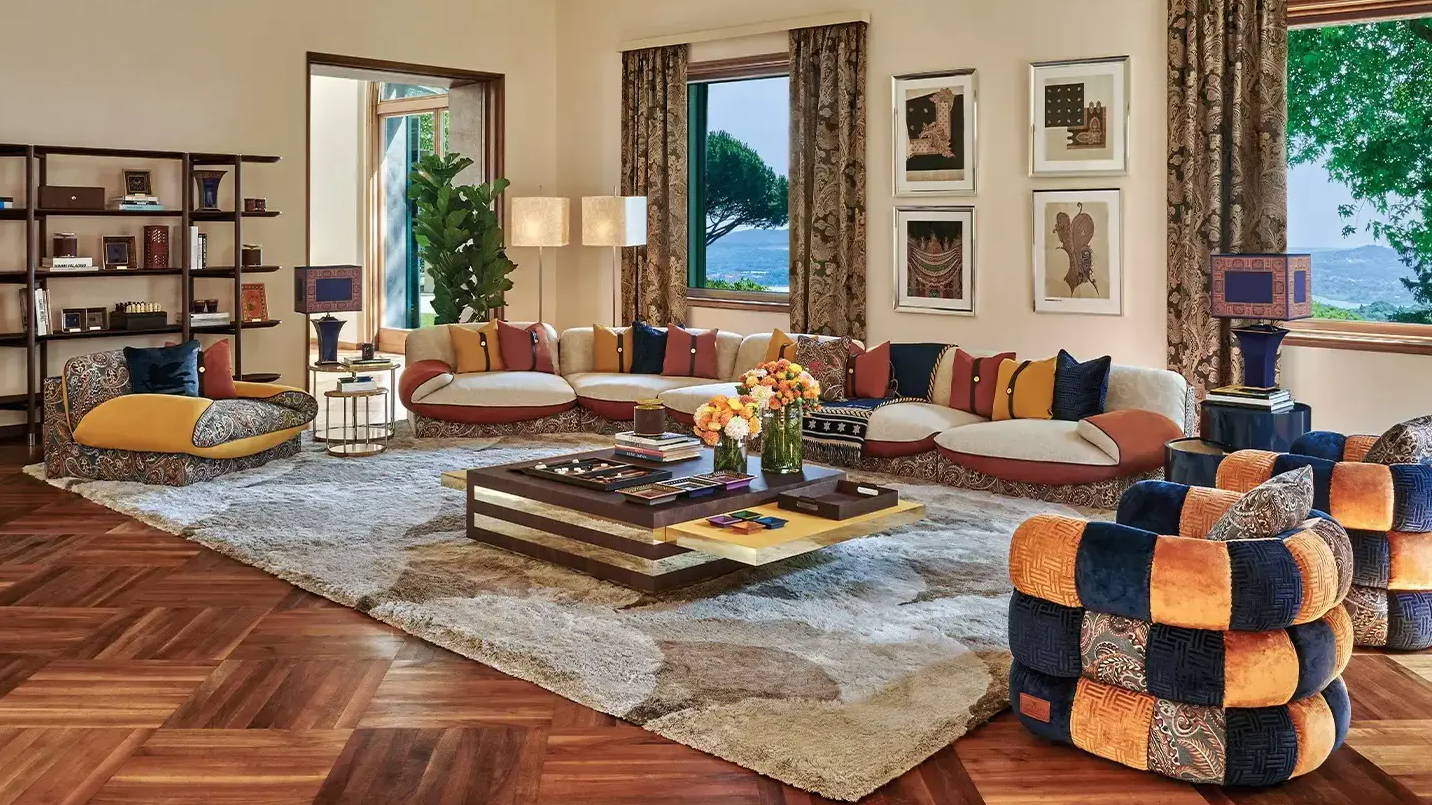 A stylish living room with colorful furniture and large windows.
