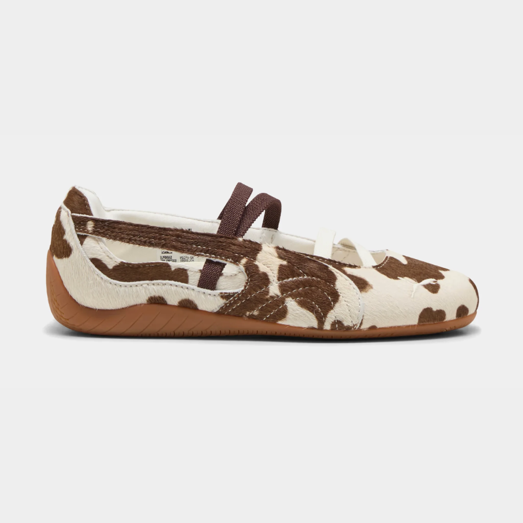 A side view of a brown and white patterned ballet flat shoe.
