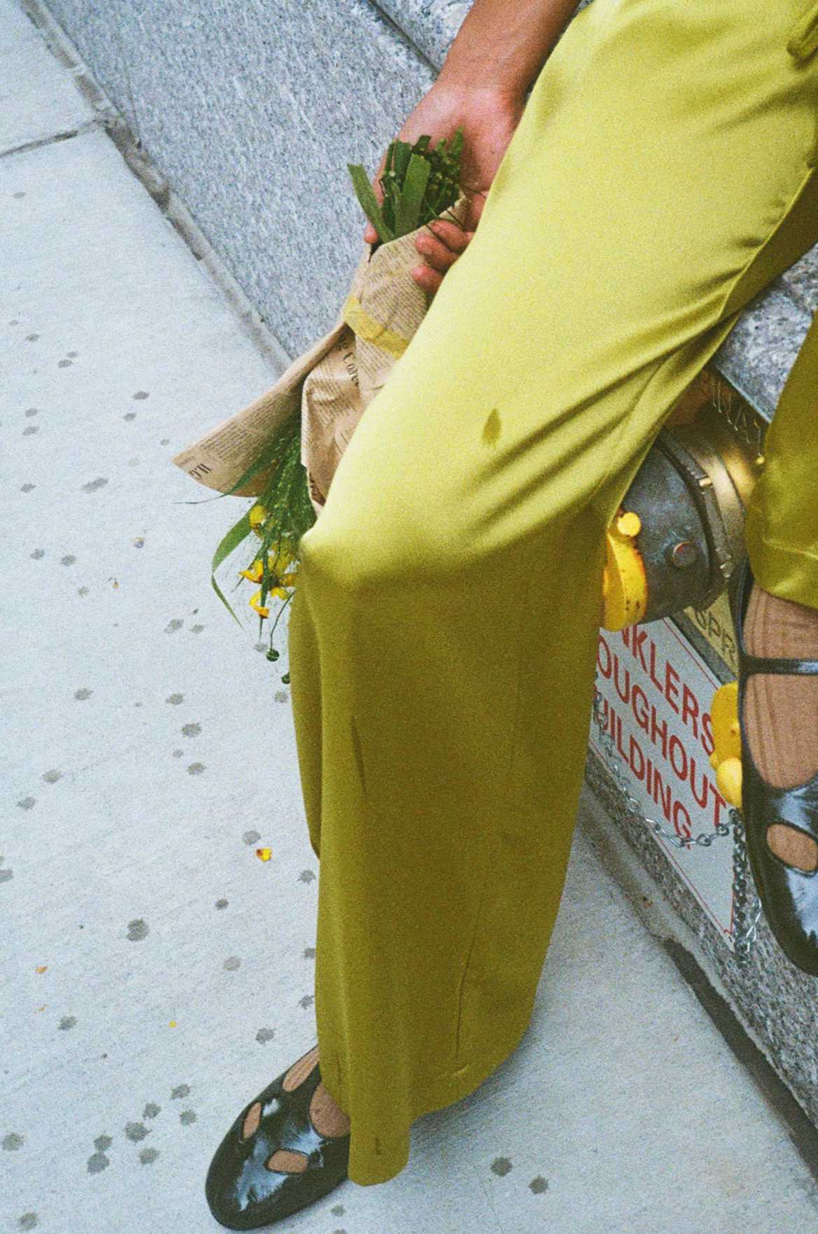 woman sitting in rain with bouquet 