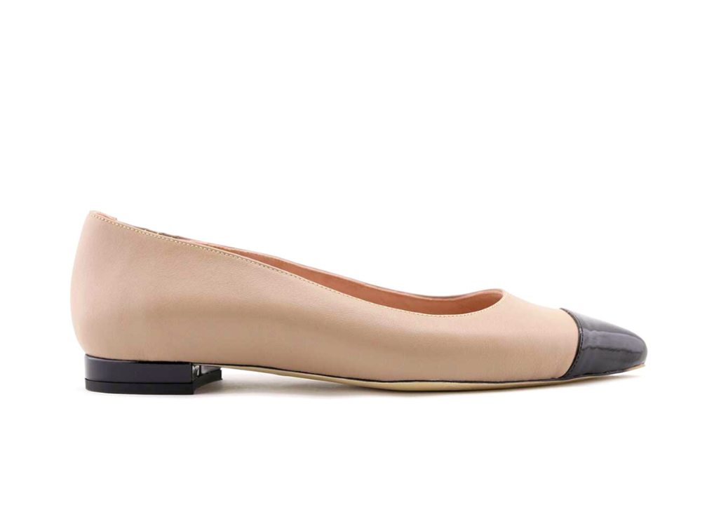 Beige ballet flat with a black toe cap.