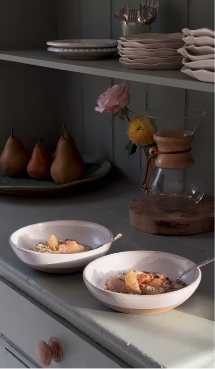 Breakfast ceramic bowls on wooden side table