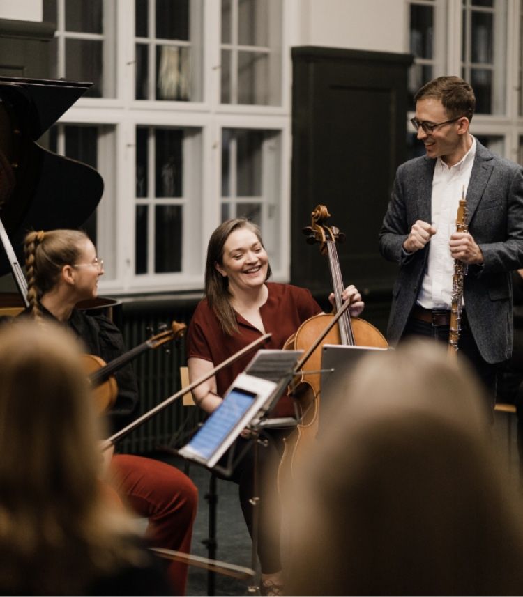 Musicians performing together in a cozy indoor setting.