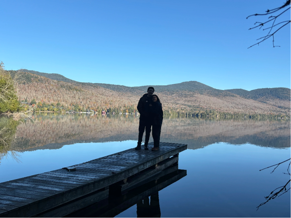 engaged couple on pier on lake placid, ny