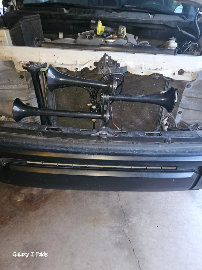 Hood open three black train horns behind grille radiator solenoid valve air lines Brian's 2015 Toyota Tundra Conductor's Special 228H customer install gallery photo 3