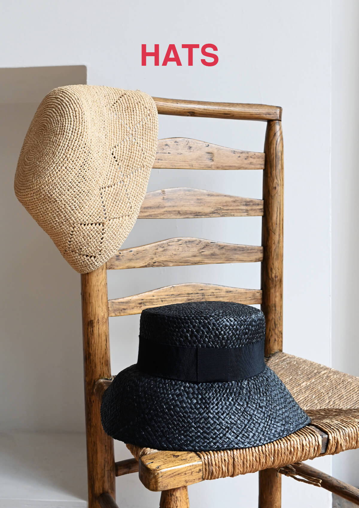 A still life image of straw hats from the SS24 collection.