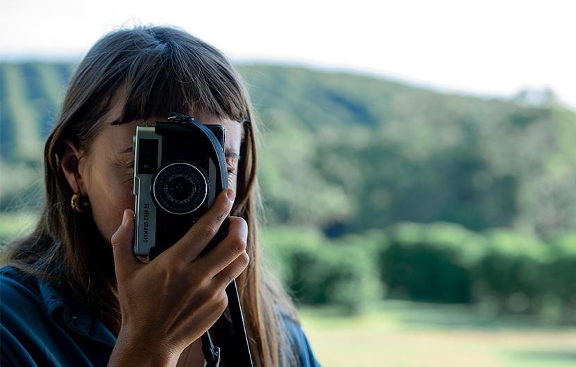 Woman taking a photo with an old camera