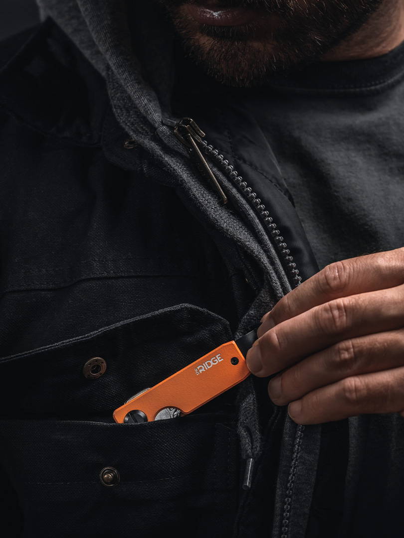 Basecamp Orange Ridge keycase pulled out from chest pocket