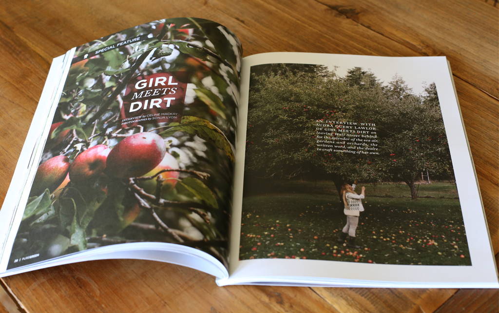 Pure Green Magazine is opened to a story of Girl Meets Dirt. Image of apples are on left side, image of Audra Lawlor on the left side. 