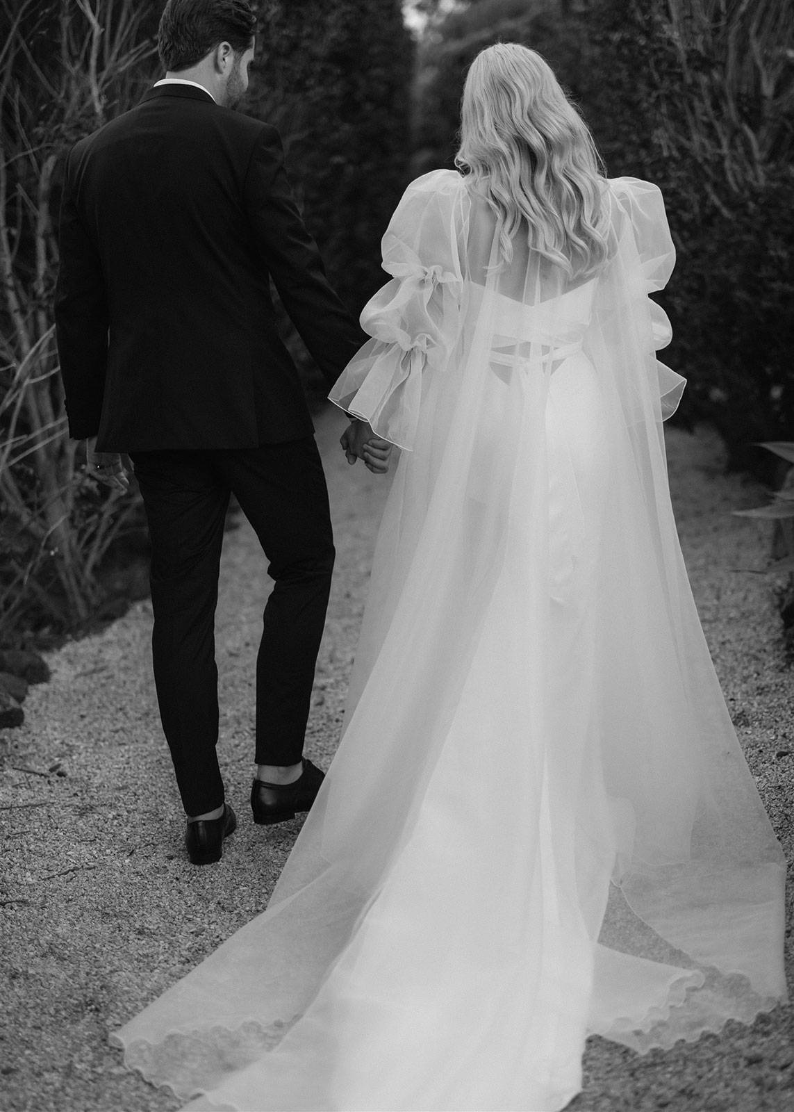 Bride and groom holding hands