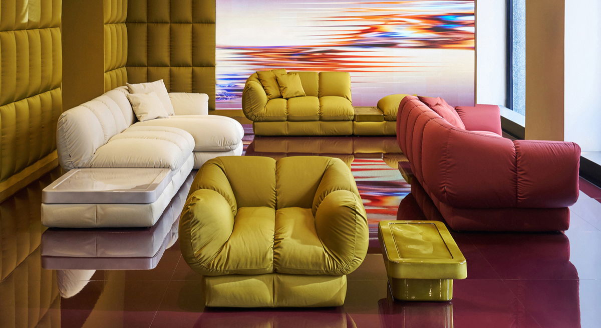 Modern display of the Ardy's collection by Cassina with colourful sofas and abstract wall art.