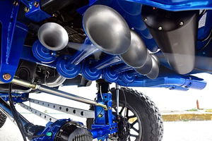 Close-up of five silver train horns and black air tank mounted on Jeff's blue-painted Ford F250 chassis
