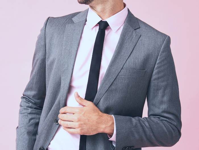 Man wearing a black skinny tie with a gray suit