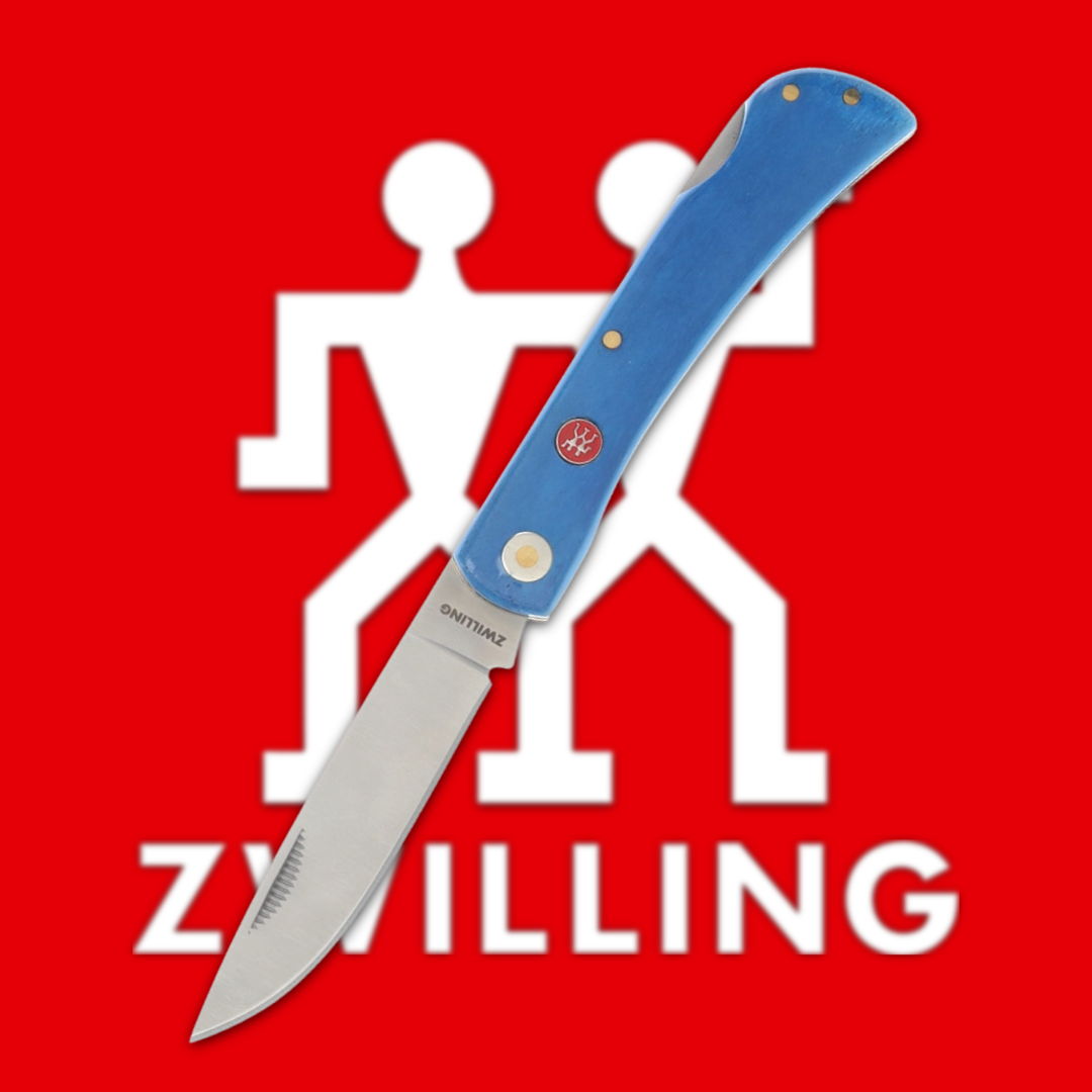 Blue-handled knife in front of a red Zwilling logo.