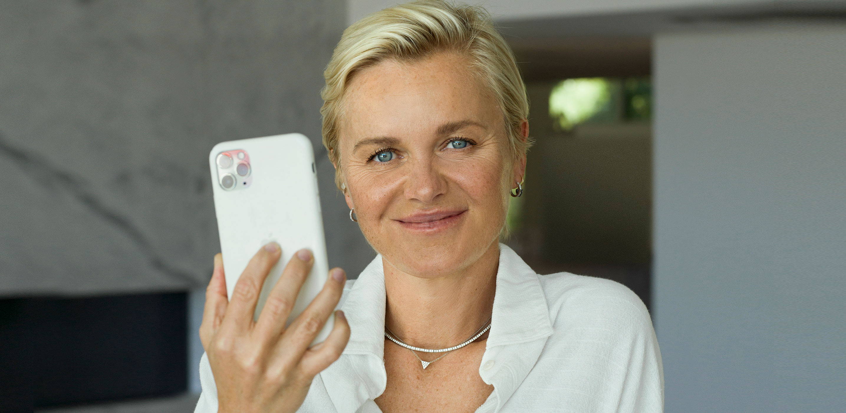 Dr Barbara Sturm portrait image holding a mobile phone