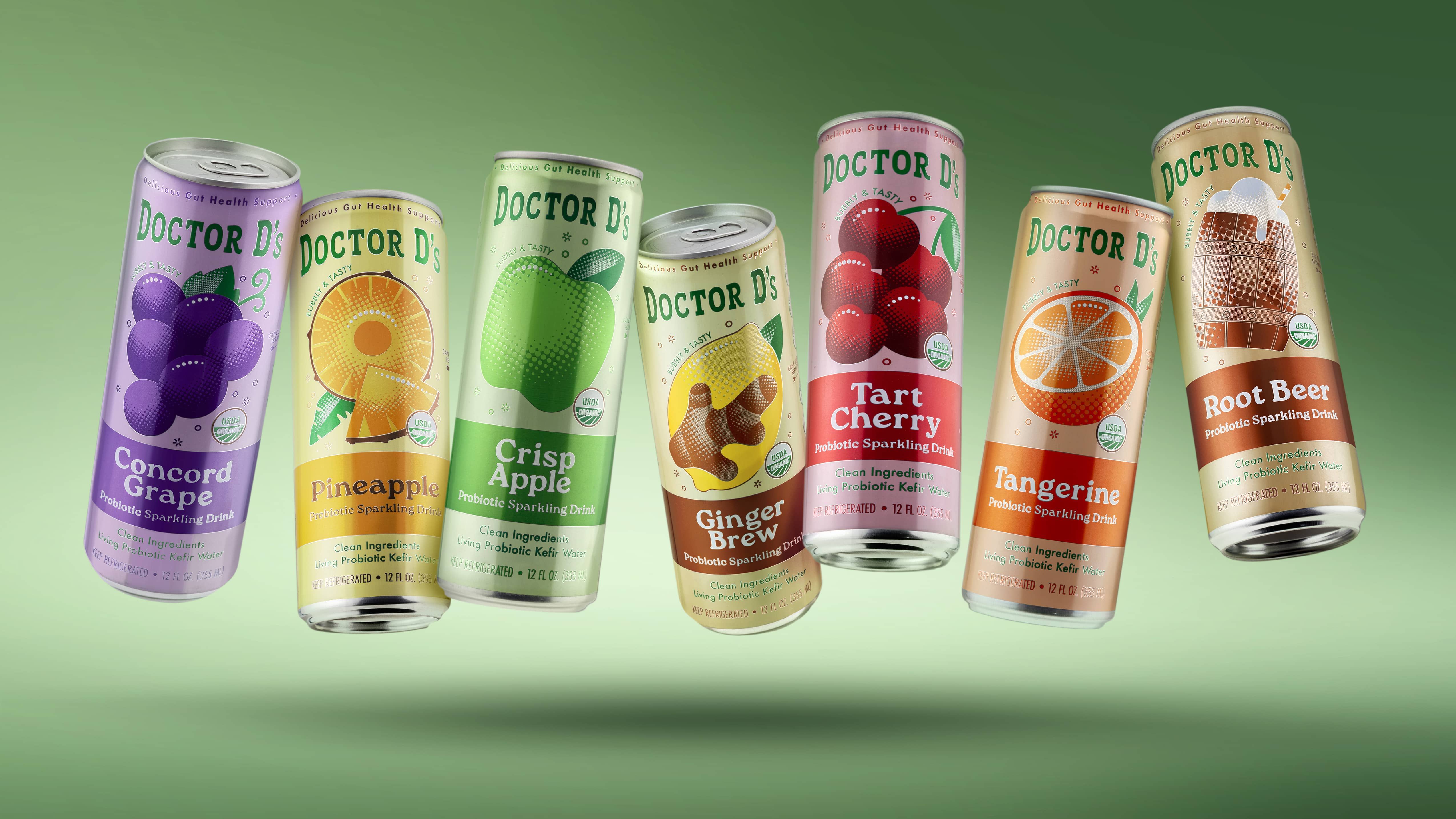 Assorted colorful beverage cans on a green background.