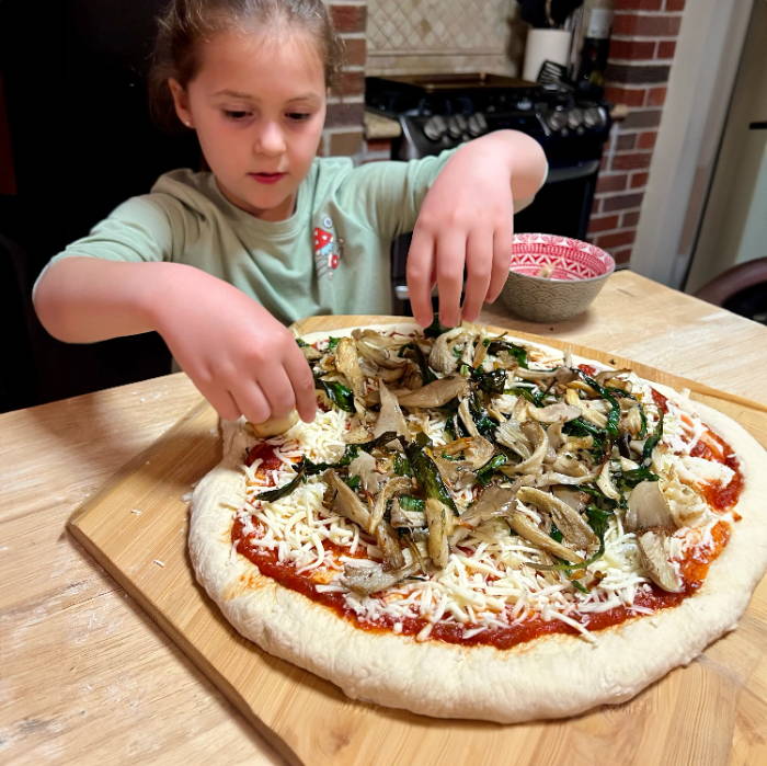 kids making pizza with homegrown mushrooms