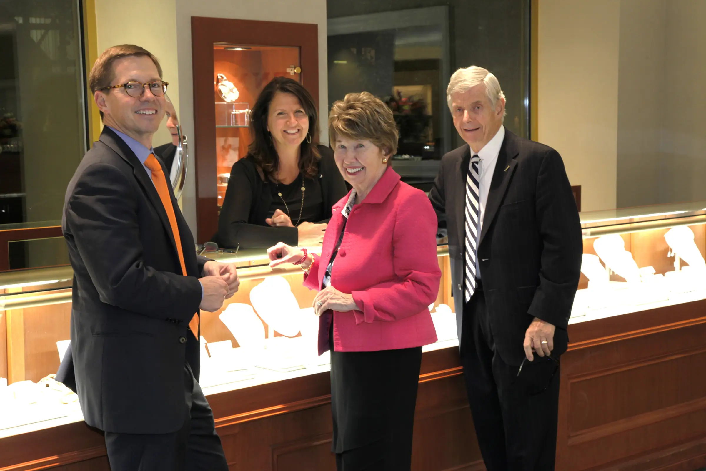 Henne team smiling, Nina behind cases