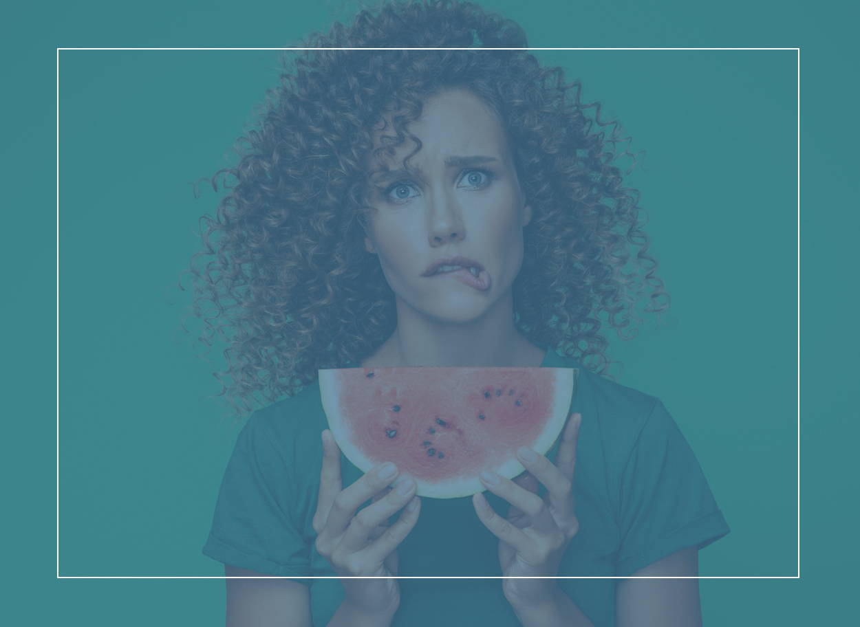 Young woman wondering why she has a tingly mouth from eating watermelon. It could be oral allergy syndrome