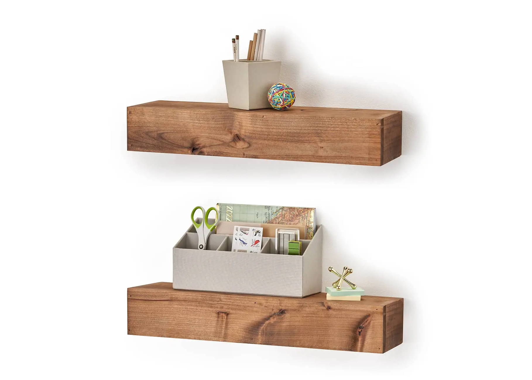 Office supplies and trinkets on the wal floating shelves