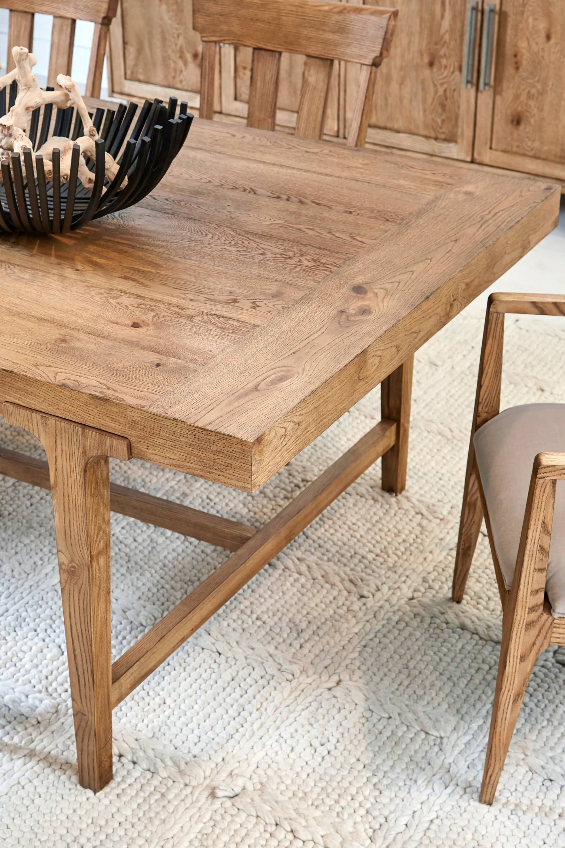 corner of wood dining table with chairs