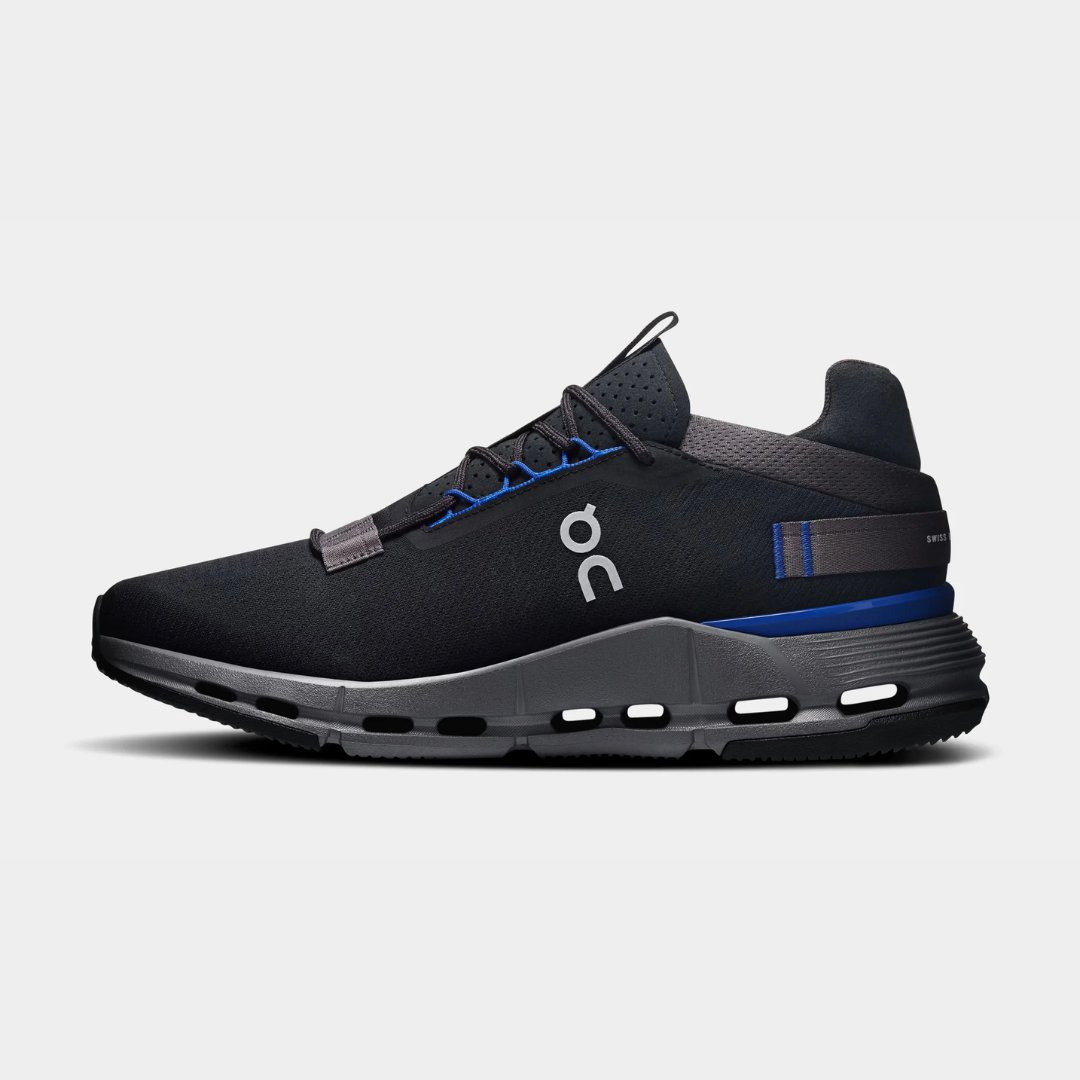 Black athletic shoes with blue accents on a light background.