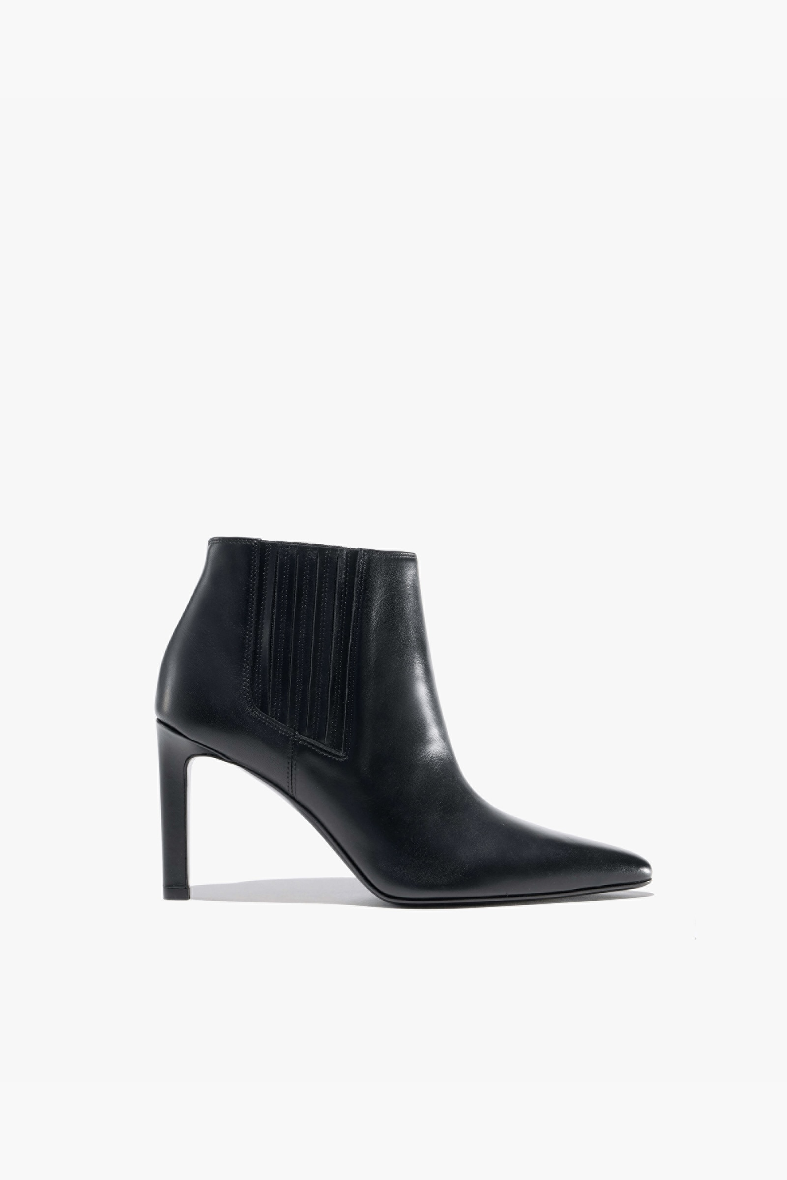 Black high-heeled ankle boot with fringe detailing.