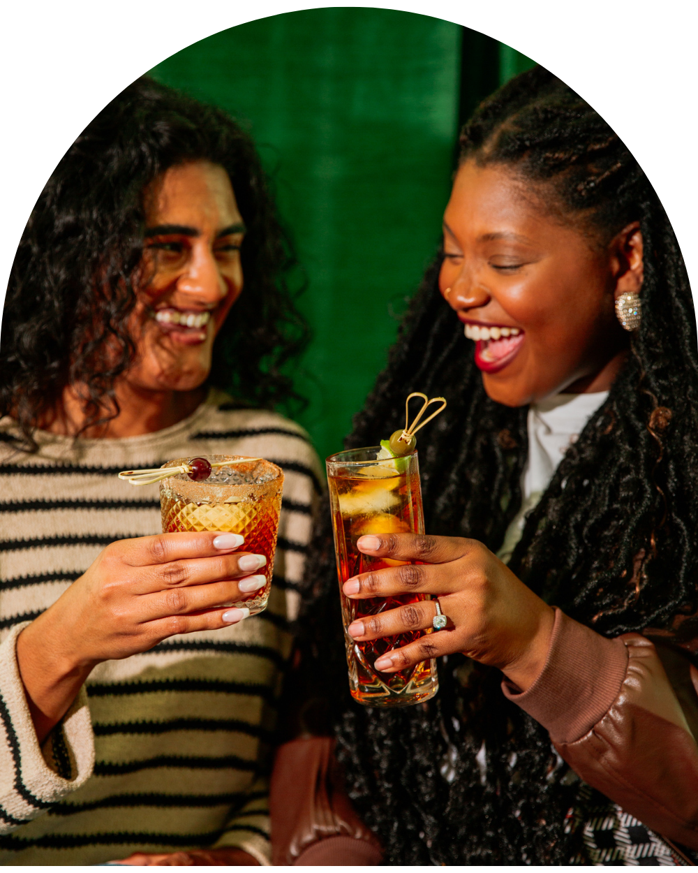 Two women clinking glasses in a cheers