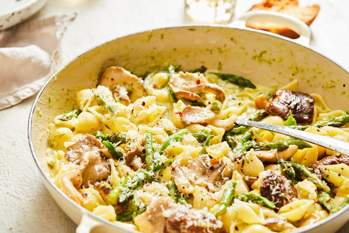 Shell pasta with mushrooms and asparagus in a creamy sauce.