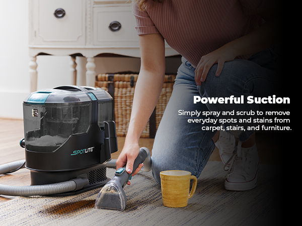 Person using a carpet cleaner on a floor, with cleaning supplies nearby.