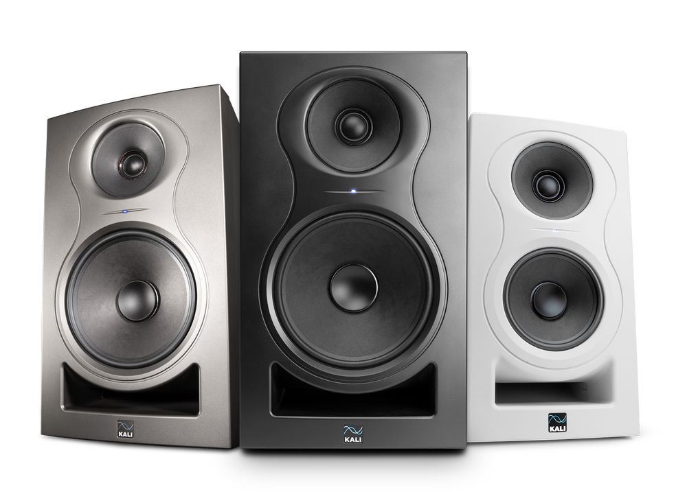 Three studio monitor speakers in black, gray, and white colors.