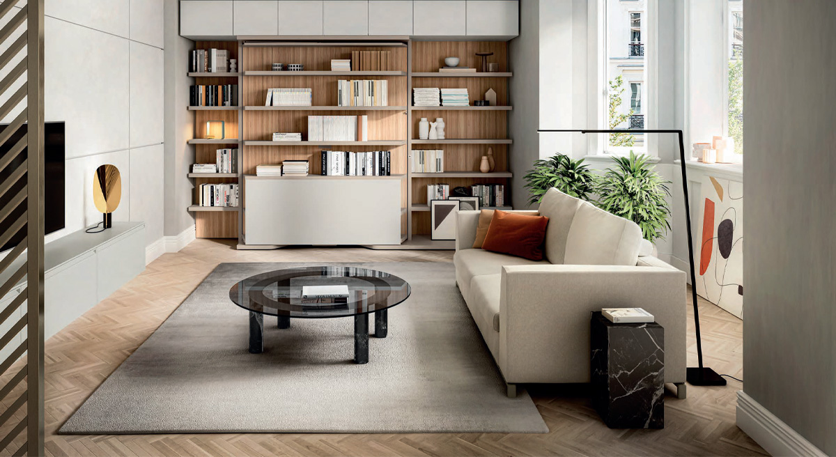 Modern Clei living room with a sofa, bed, bookshelf, and decorative plants.