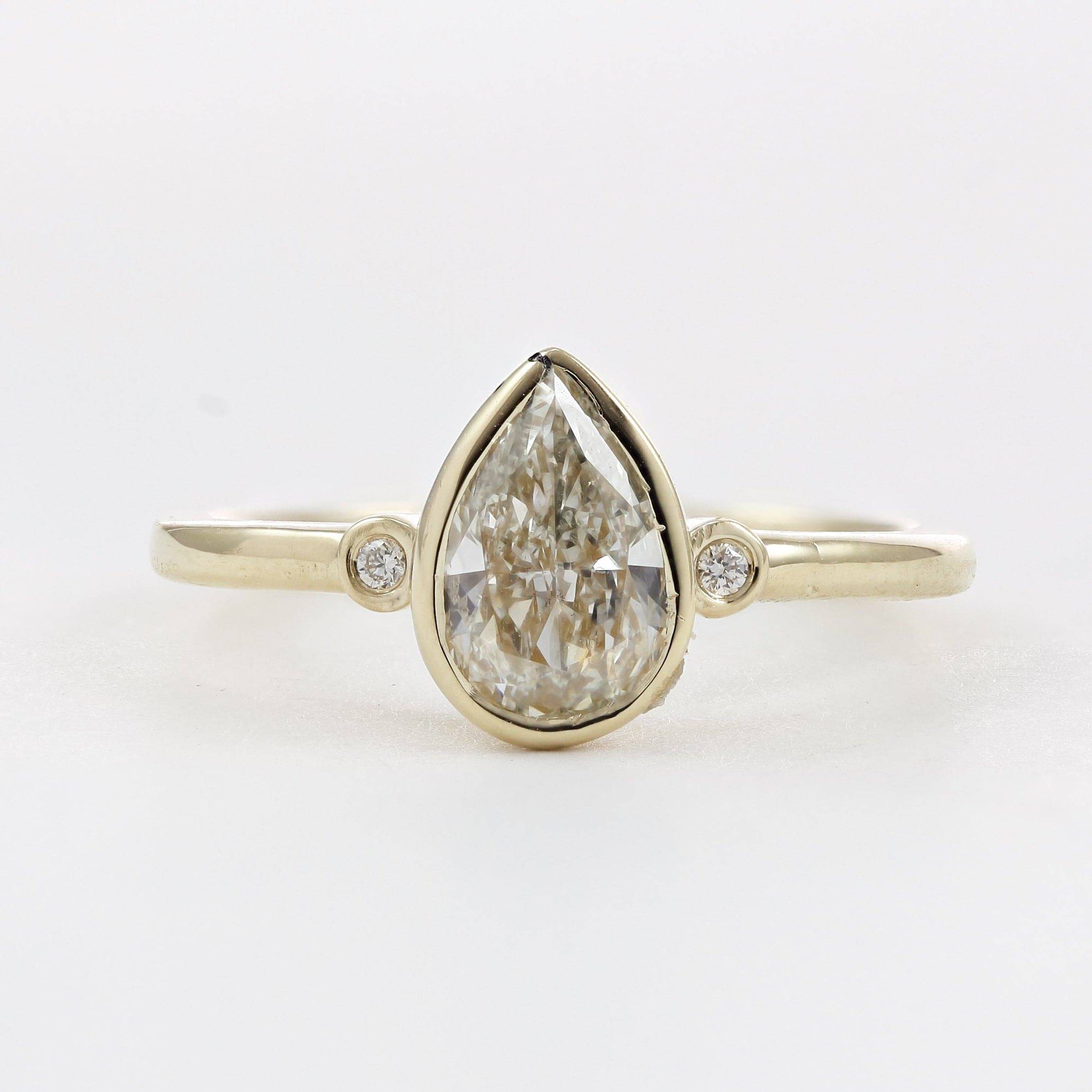 three stone ring with pear shape center