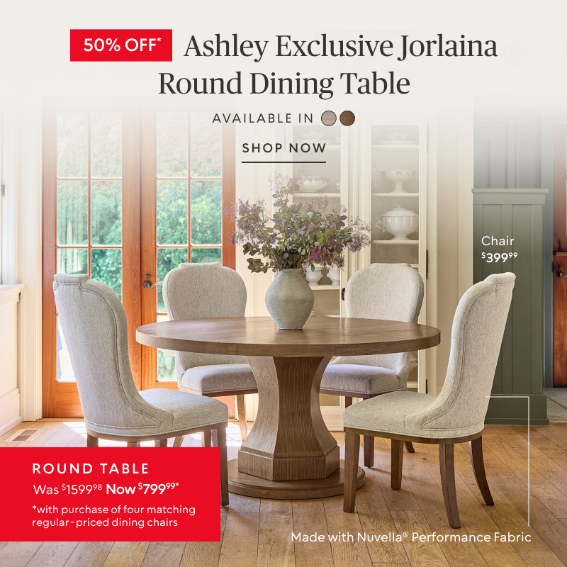 50% off Ashley Exclusive Jorlaina Round Dining Table was $1599.98 now $799.99 when you buy four matching regular price chairs