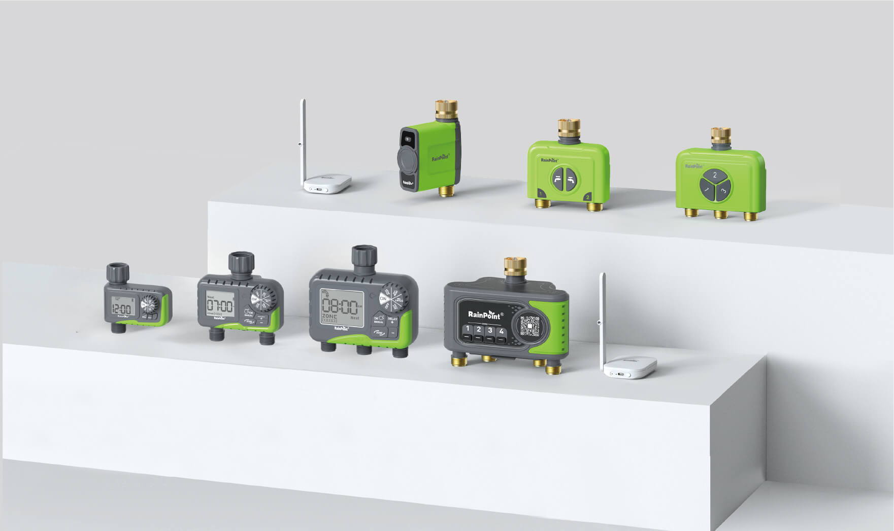 Various green and gray electronic devices displayed on a white pedestal.
