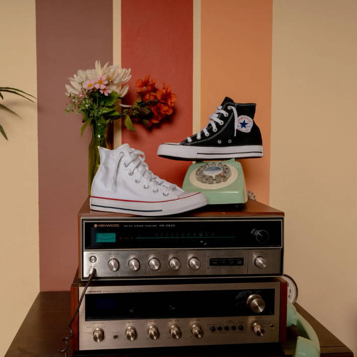white converse and black converse with vintage background