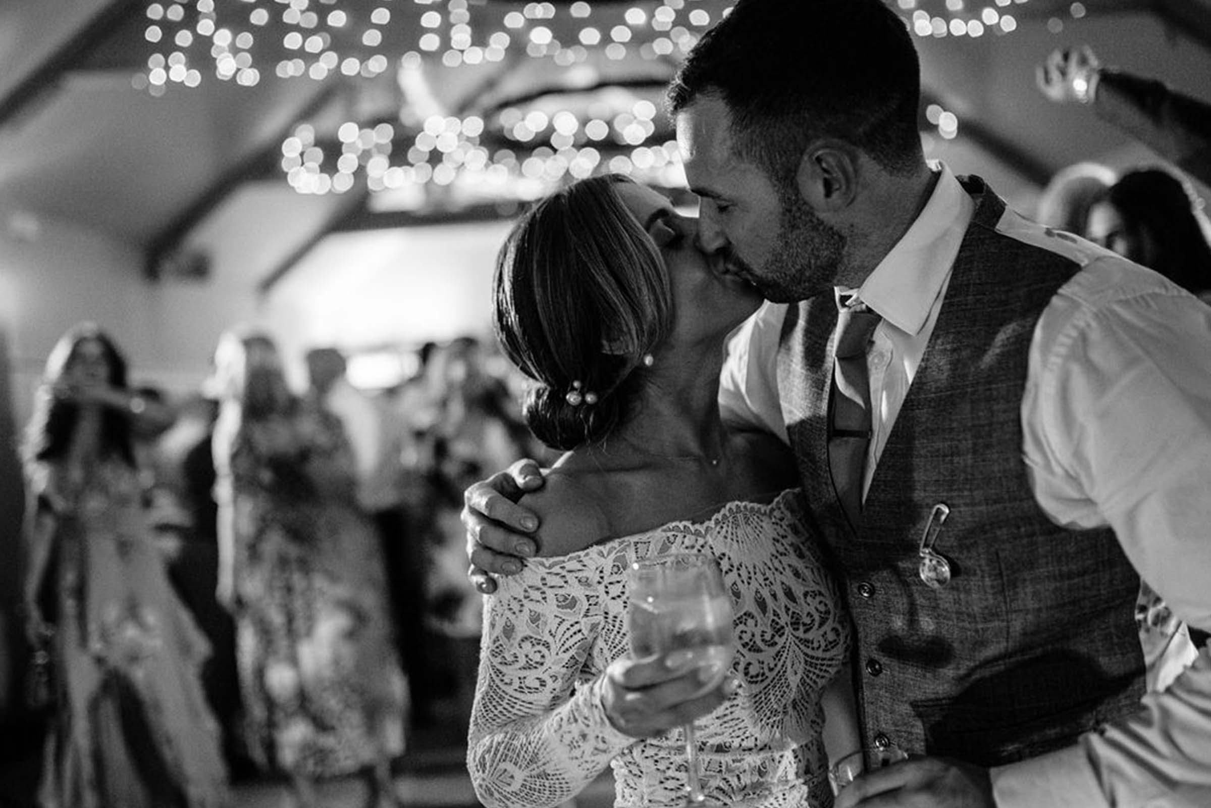 Bride and groom sharing a kiss at their wedding reception