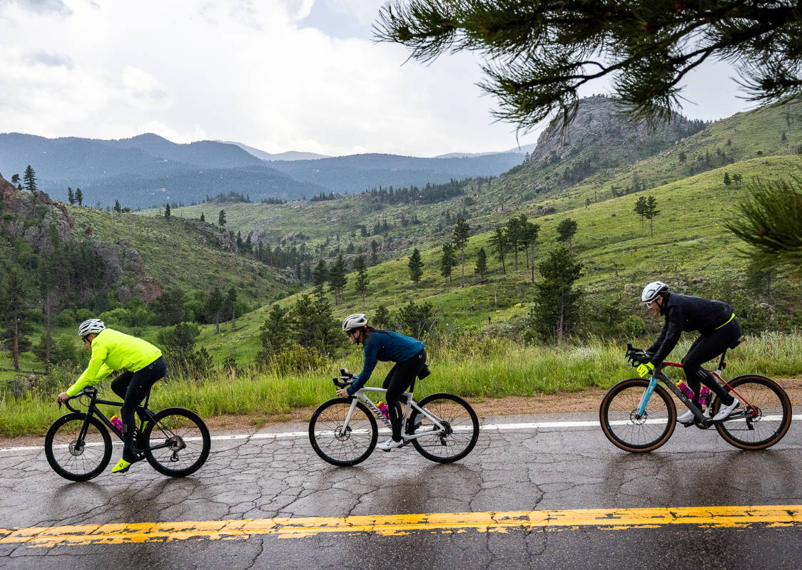 Group of cyclist riding in the mountain rain.
