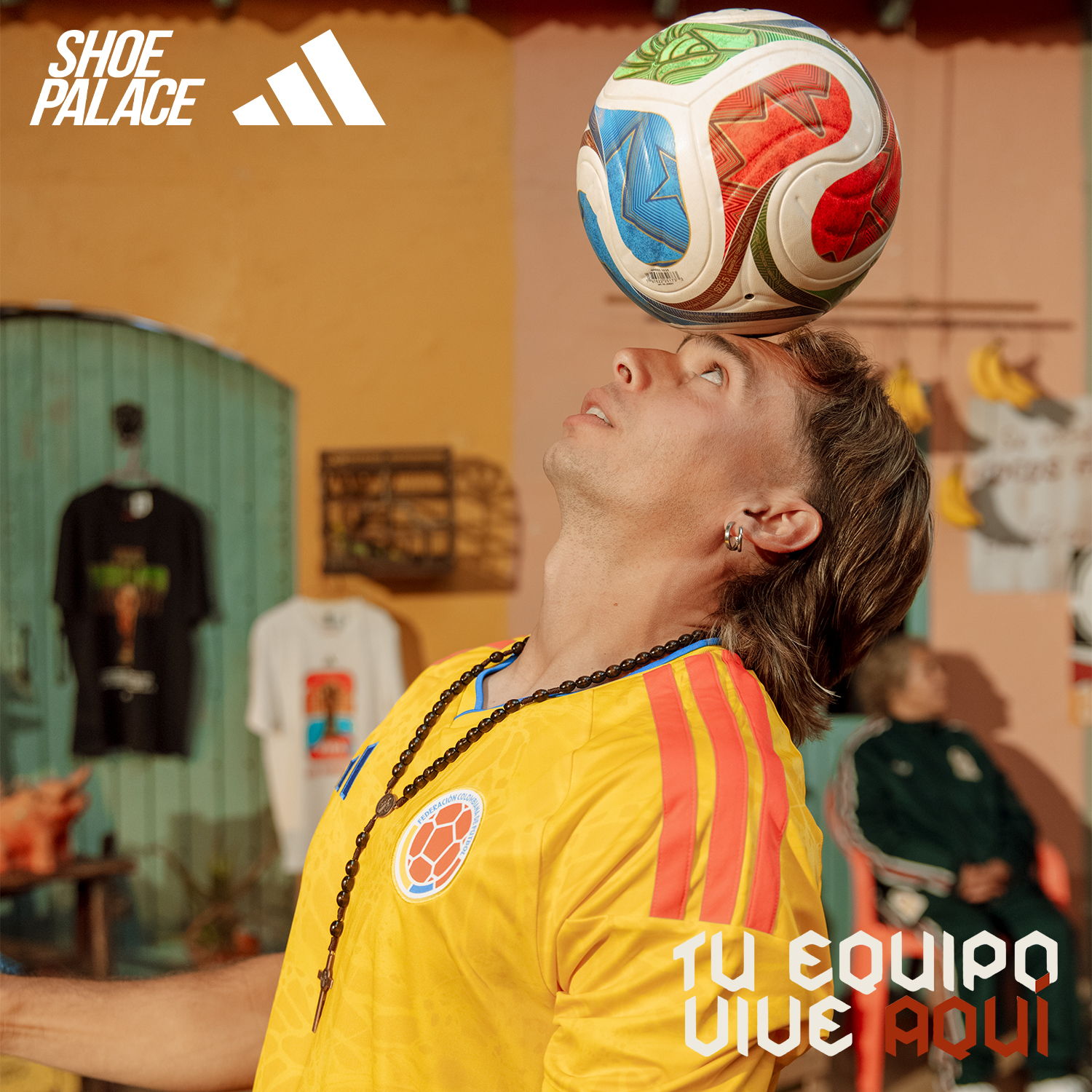 Person balancing a soccer ball on their head, wearing a yellow jersey.