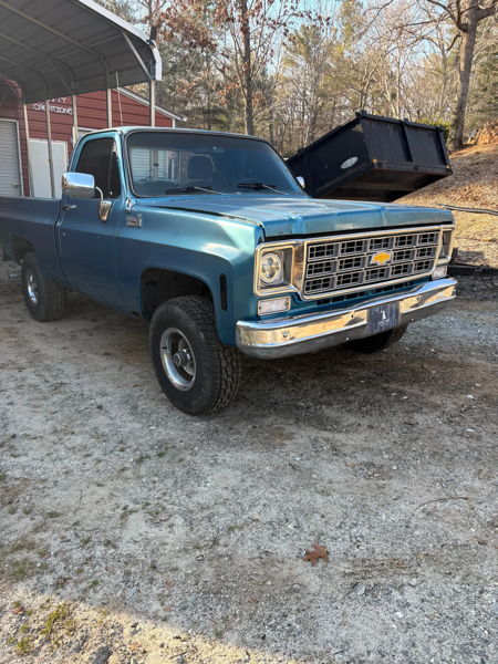 Front three-quarter view of Sammy's blue 1976 Chevy K10 parked outside the shop, install photo 3
