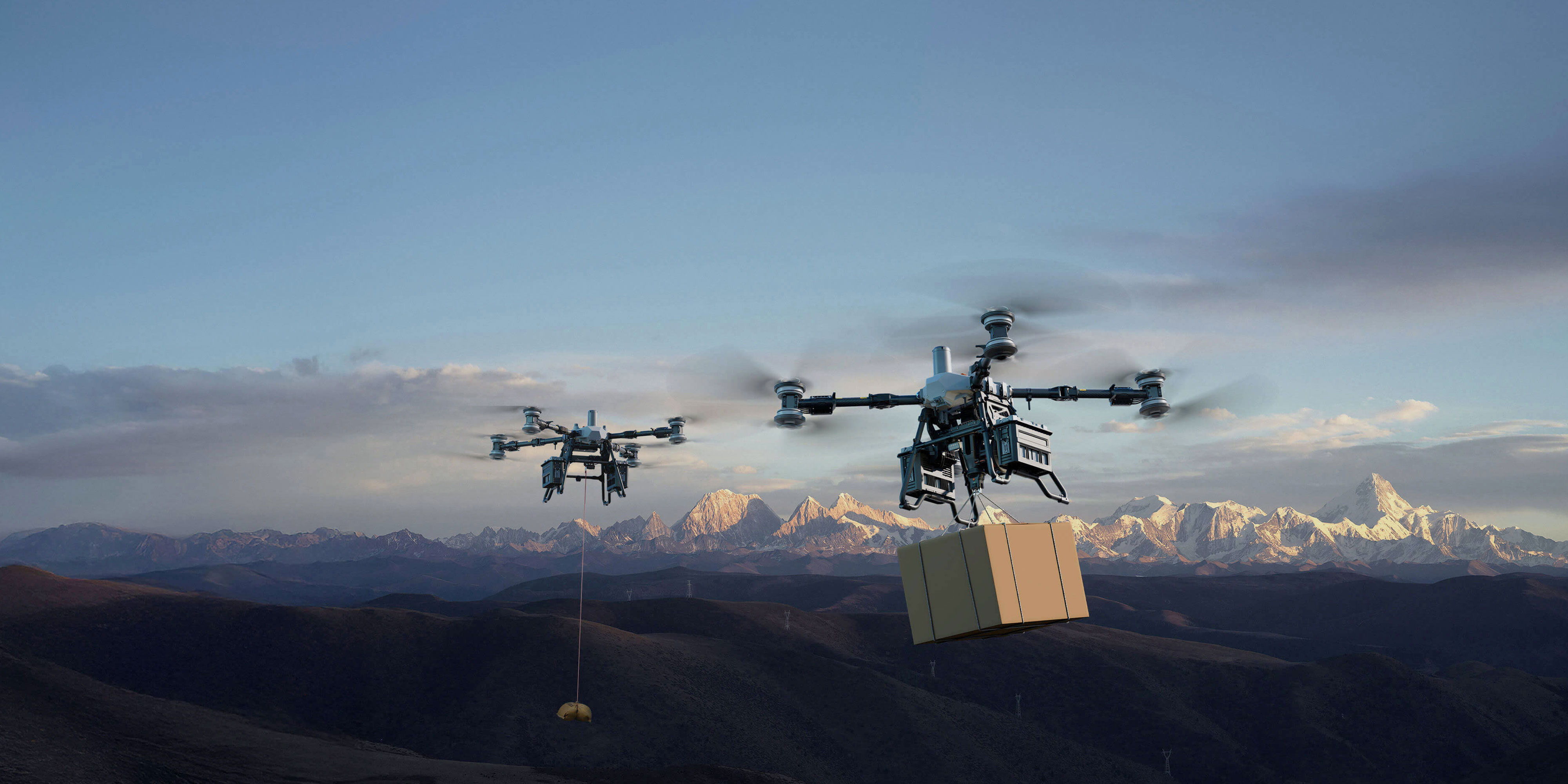 Two DJI FlyCart drones flying over mountains while transporting goods.