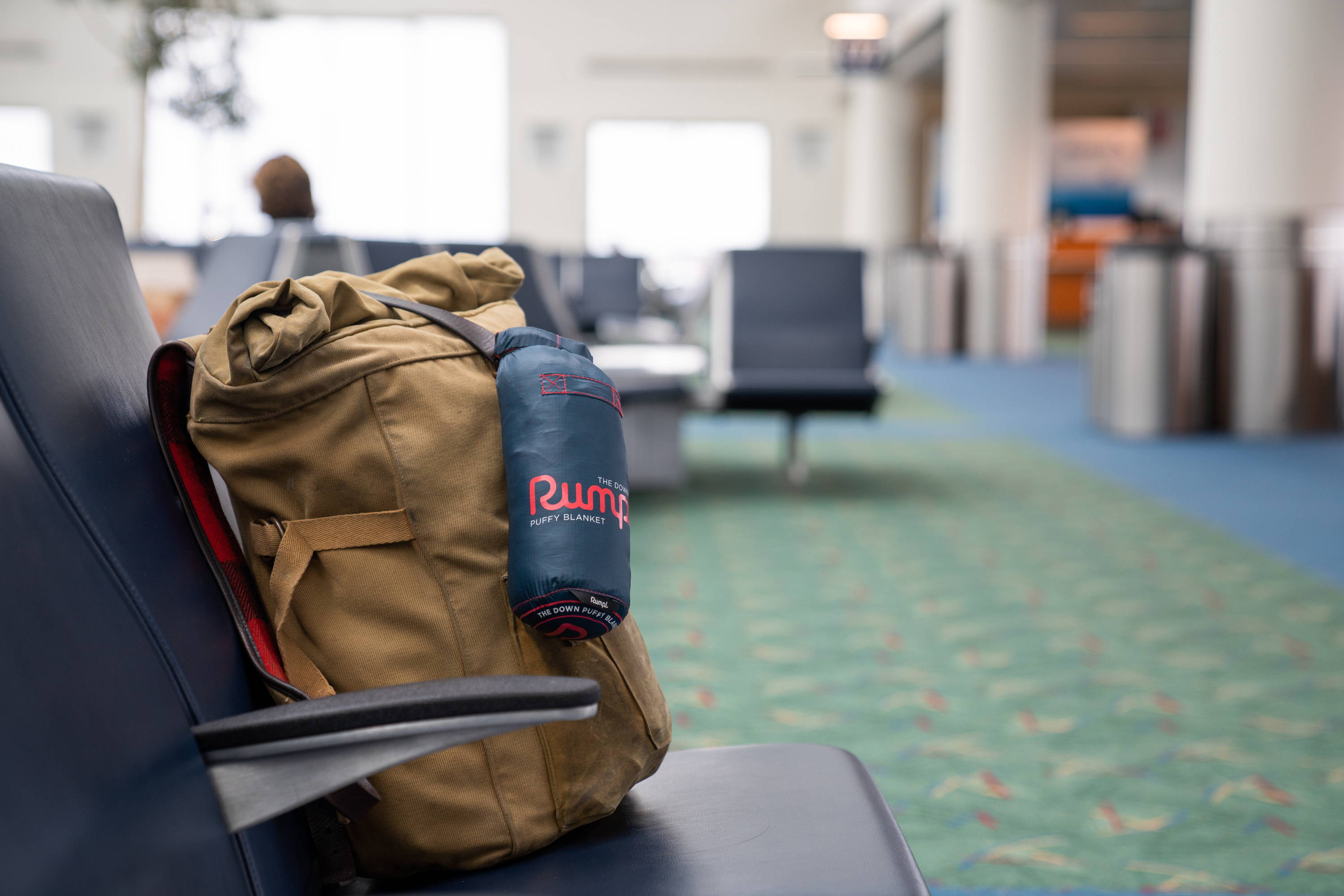 Rumpl Travel blanket attached to bag in airport