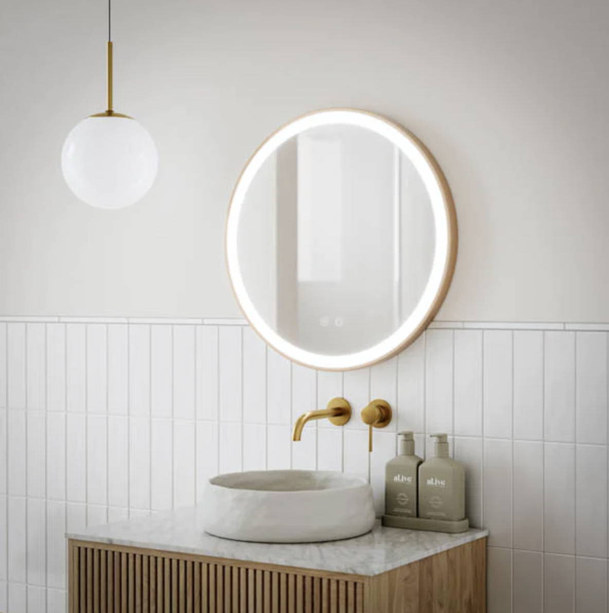 Light and airy bathroom with gold framed LED Mirror