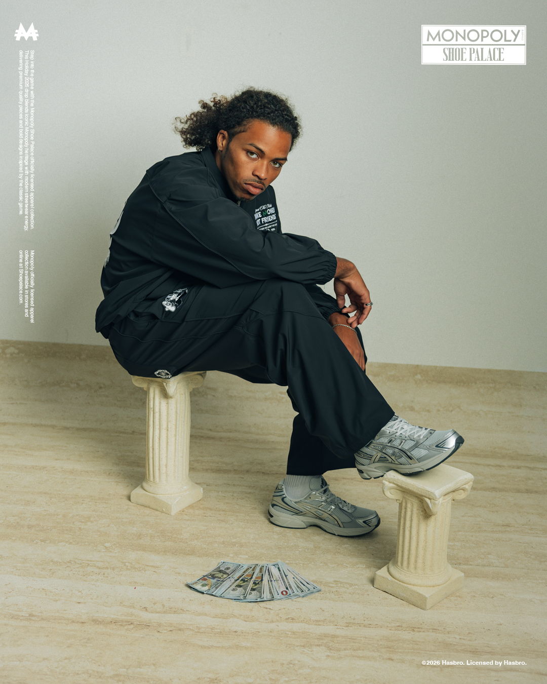 Person sitting on a column, surrounded by cash, wearing athletic clothing.