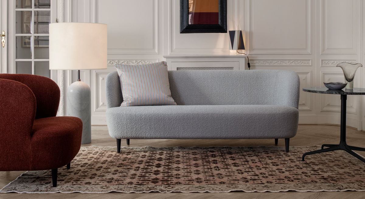 Living room with a gray Stay sofa by Gubi, red chair, lamp, and coffee table.