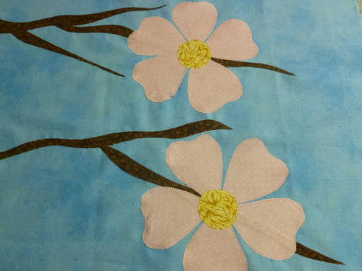 A third half-flower appliqued onto the background to add a focal point