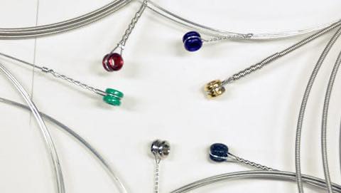 Colorful connectors attached to wires against a white background.