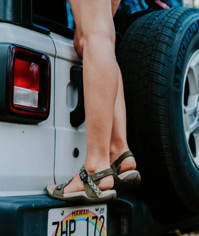 woman next to car wearing wide sandals