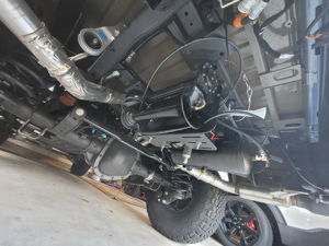 Underside view of train horn and air tank installation on Ford F150